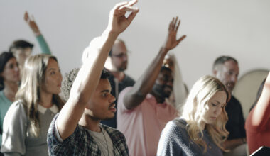 People Raising Their Hands In A Seminar