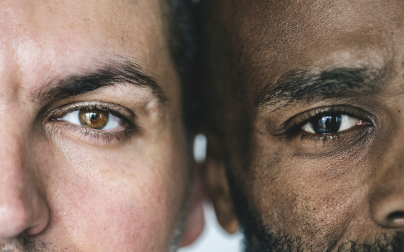 Two different ethnic men's eyes closeup