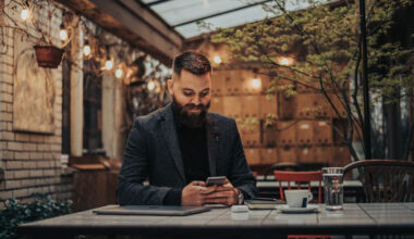 Businessman Using A Smartphone I Na Cafe